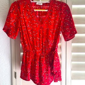 Red short-sleeved peekaboo blouse with side tie.